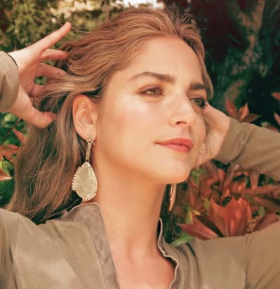 Girl with earrings with tree on background