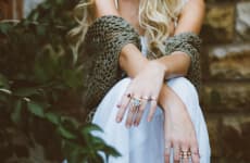 Girl sitting on stairs with rings on hands